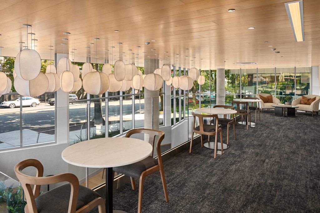 a large room with tables and chairs and large windows