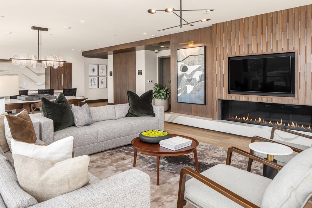 a living room with couches and chairs and a fireplace