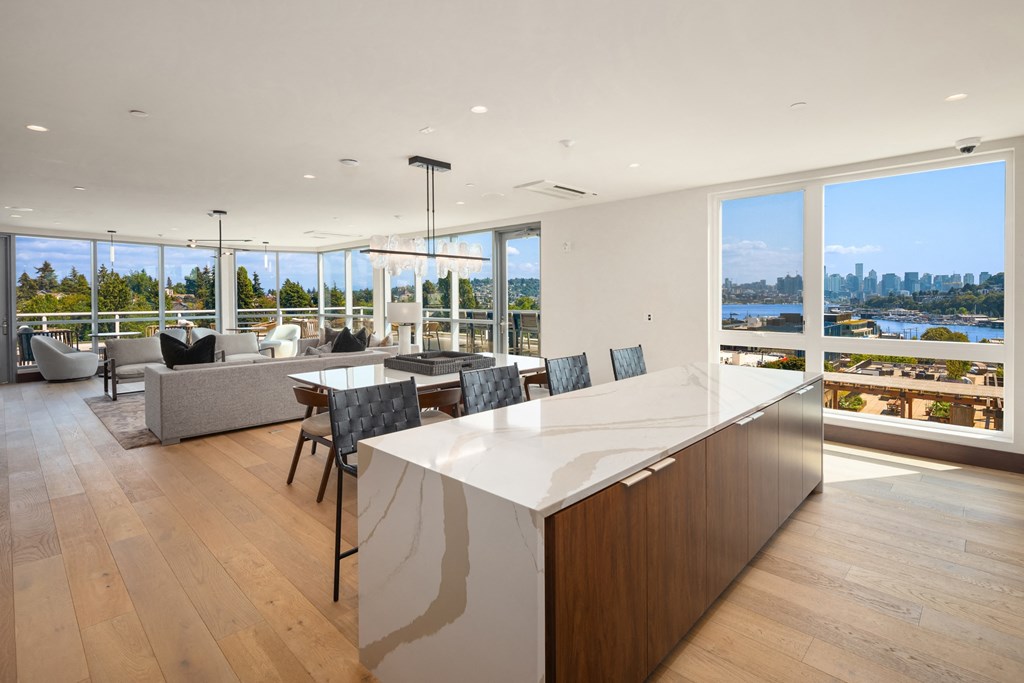 a  large kitchen and living room with a large island and a view of the city