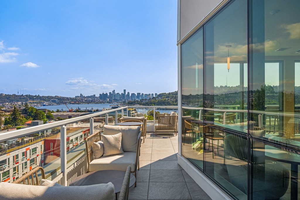 a  view of the city from the balcony of a condo with glass windows