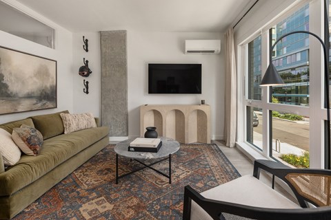 a living room with a couch and a table and a large window