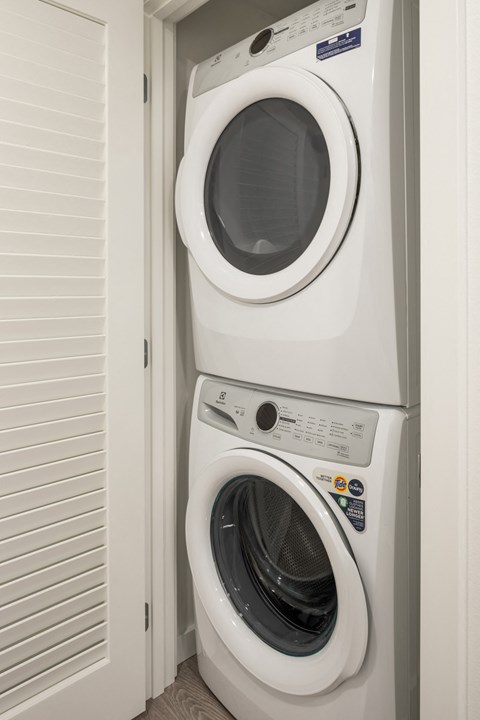 a front loading washer and dryer in a laundry room