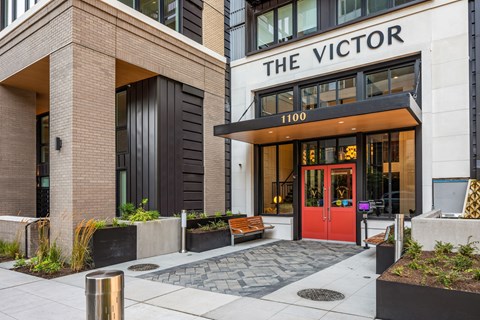 the victory entrance to a building with a red door