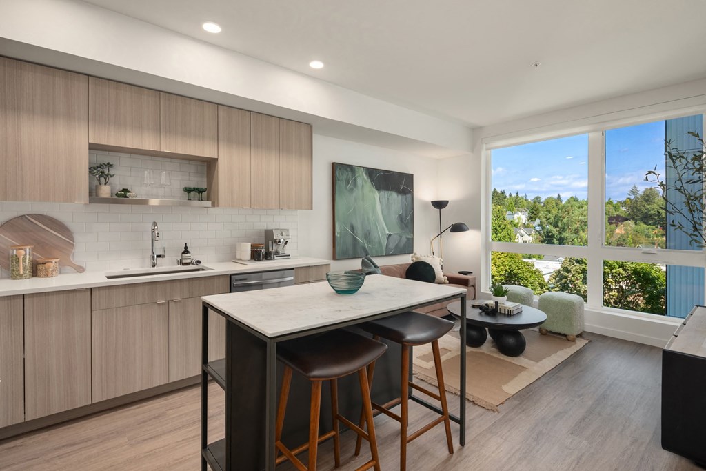 an open kitchen and living room with a large window