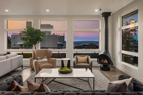 a living room with a couch and a coffee table and a fireplace
