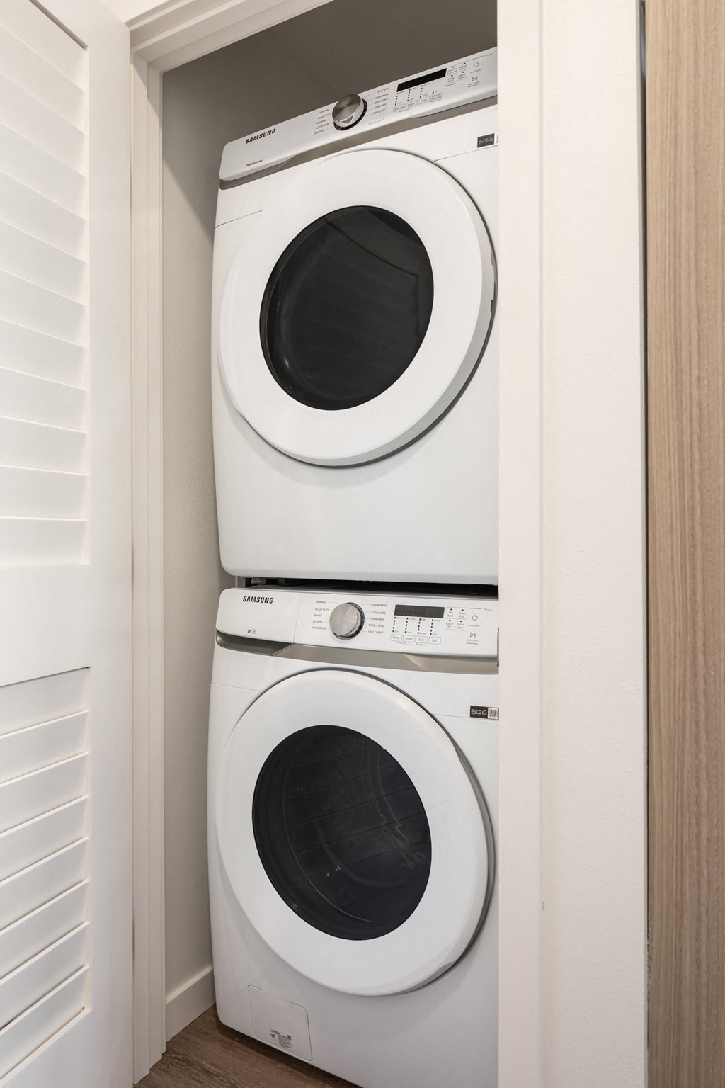 a washer and dryer are stacked on top of each other in a closet