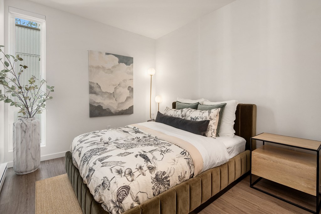 a bedroom with a large bed and a window