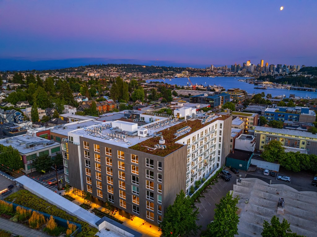 an aerial view of an apartment building with a city in the background