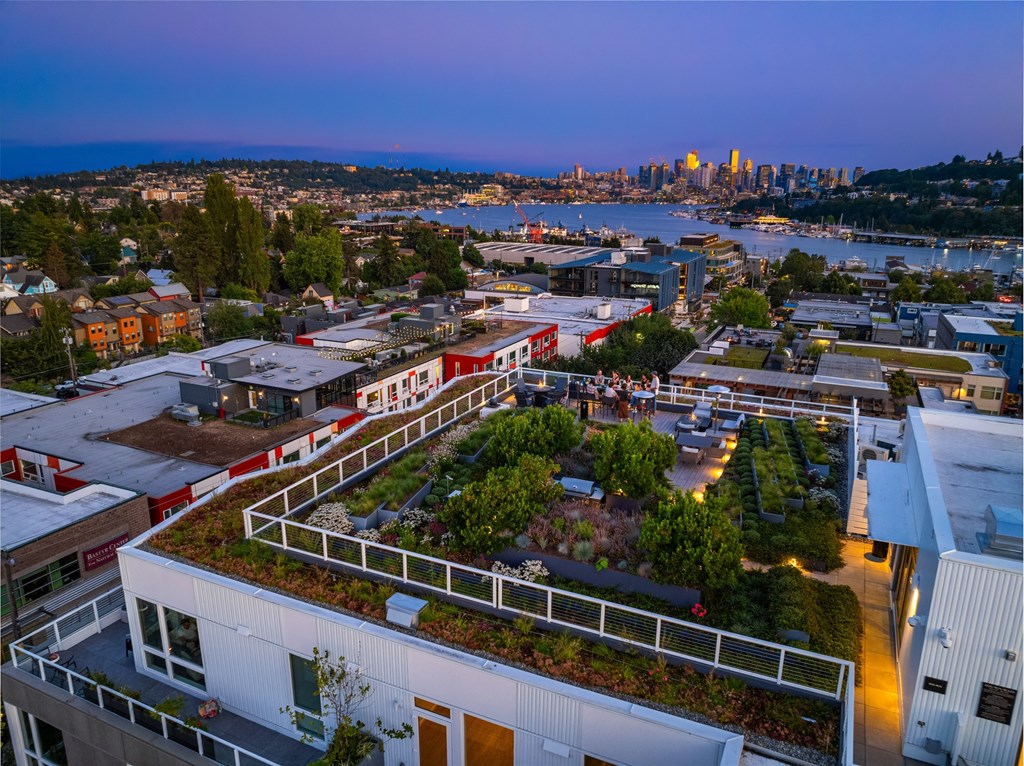a green roof on a building with a city in the background