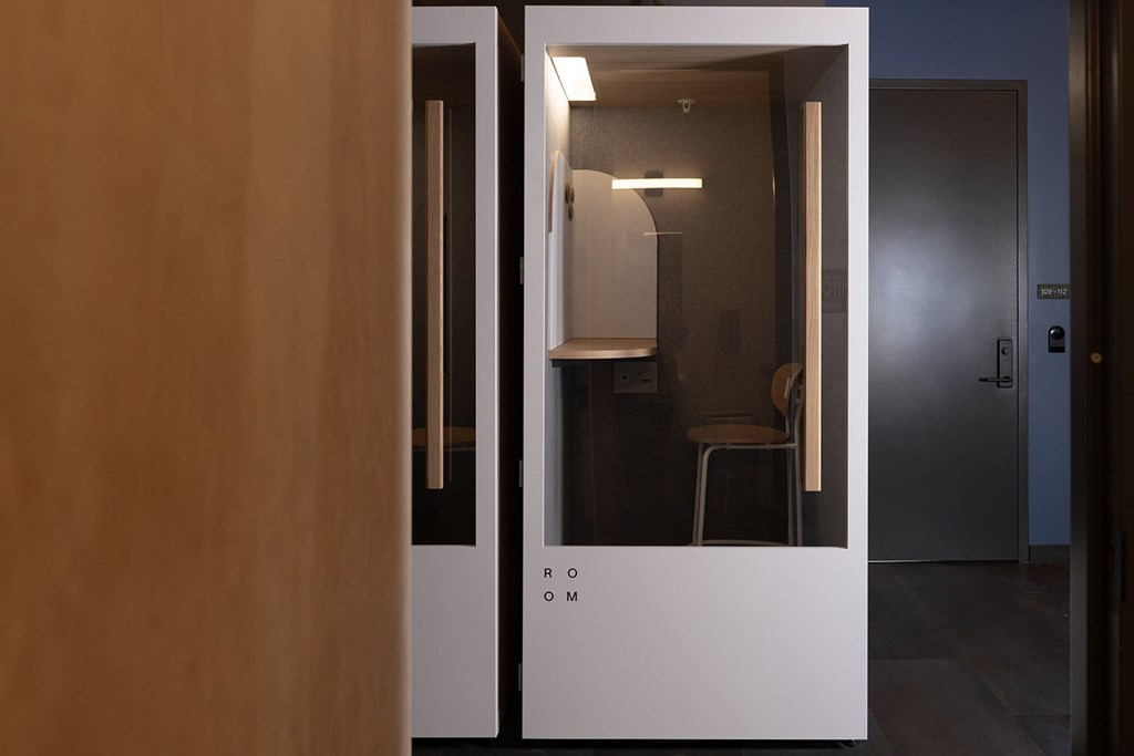 A white door with a glass window is open.