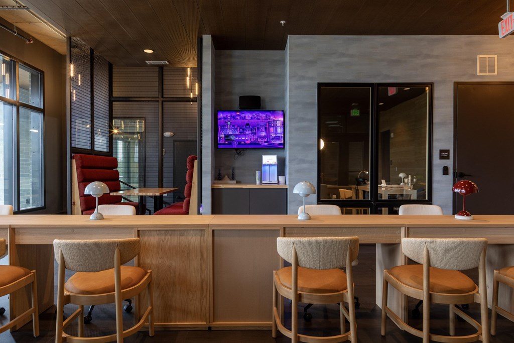 A bar area with a television on the wall.