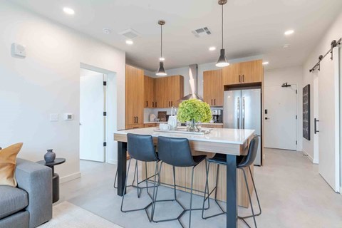A modern kitchen with a dining table and chairs.