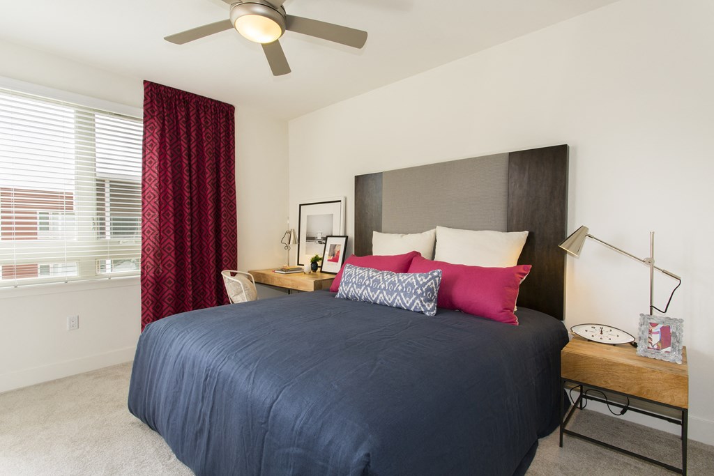 bedroom with large window and bed