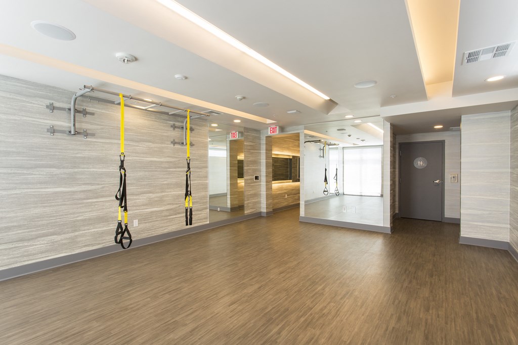 a large room with wood floors and white walls