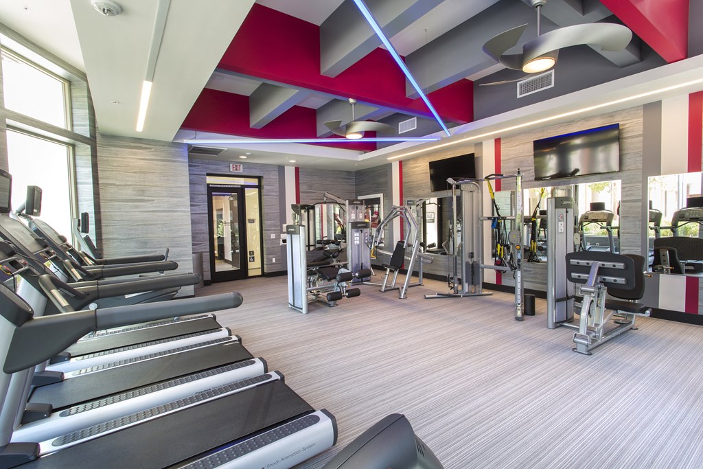 a spacious fitness center with treadmills and other exercise equipment