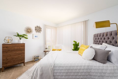 a bedroom with white walls and a large bed