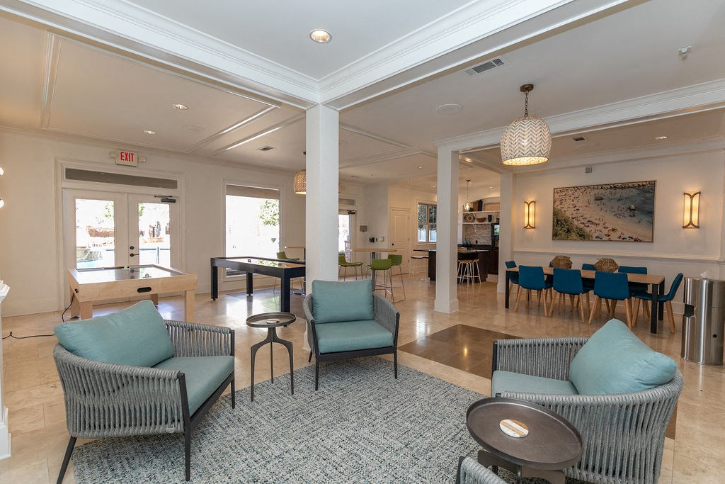 a resident clubhouse with couches tables and chairs and a pool table at Westmount at Ashwood, Atlanta, Georgia