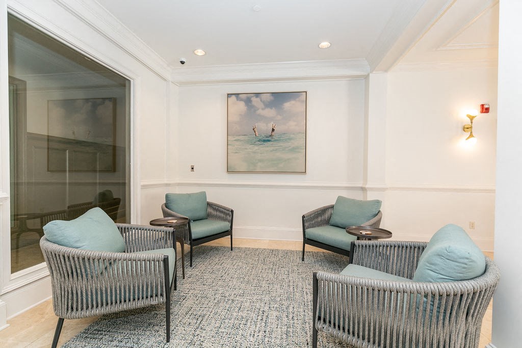 a waiting room with chairs and a painting of two people on a surfboard at Westmount at Ashwood, Atlanta