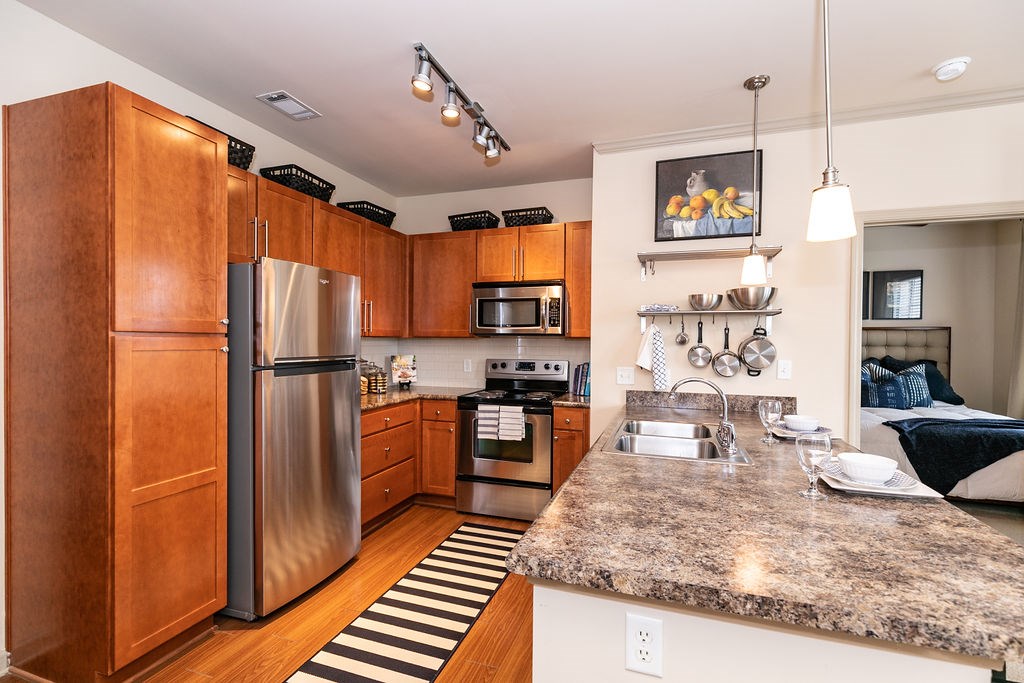 A kitchen with wooden cabinets and granite countertops.