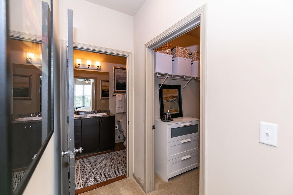 A white cabinet with a drawer is open to a laundry room.
