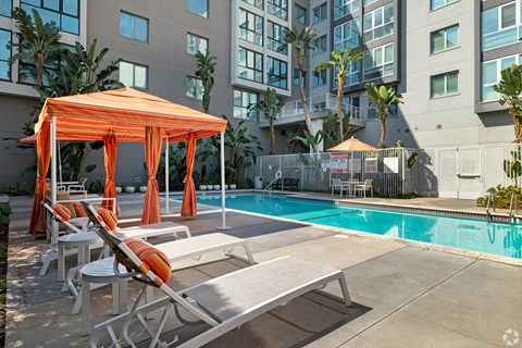 A pool area with sun loungers and a canopy at Wilshire Vermont, Koreatown, Los Angeles
