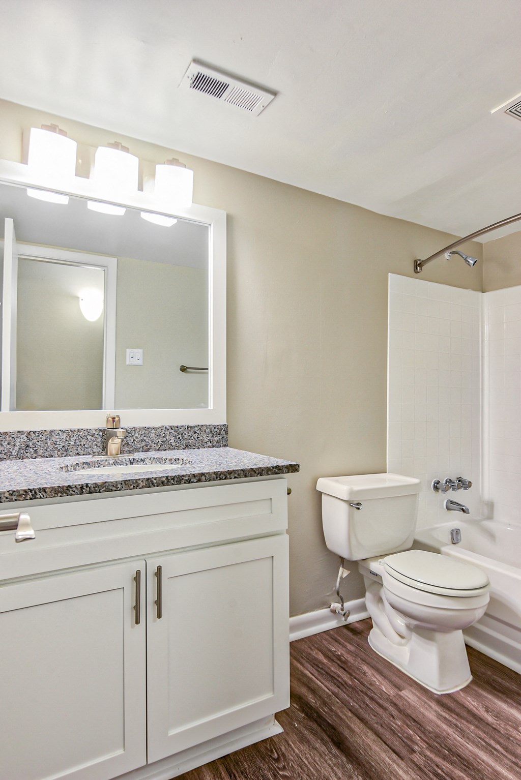 a bathroom with a toilet sink and shower