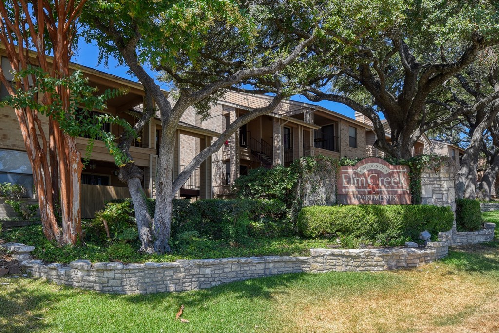 a large house with trees in front of it