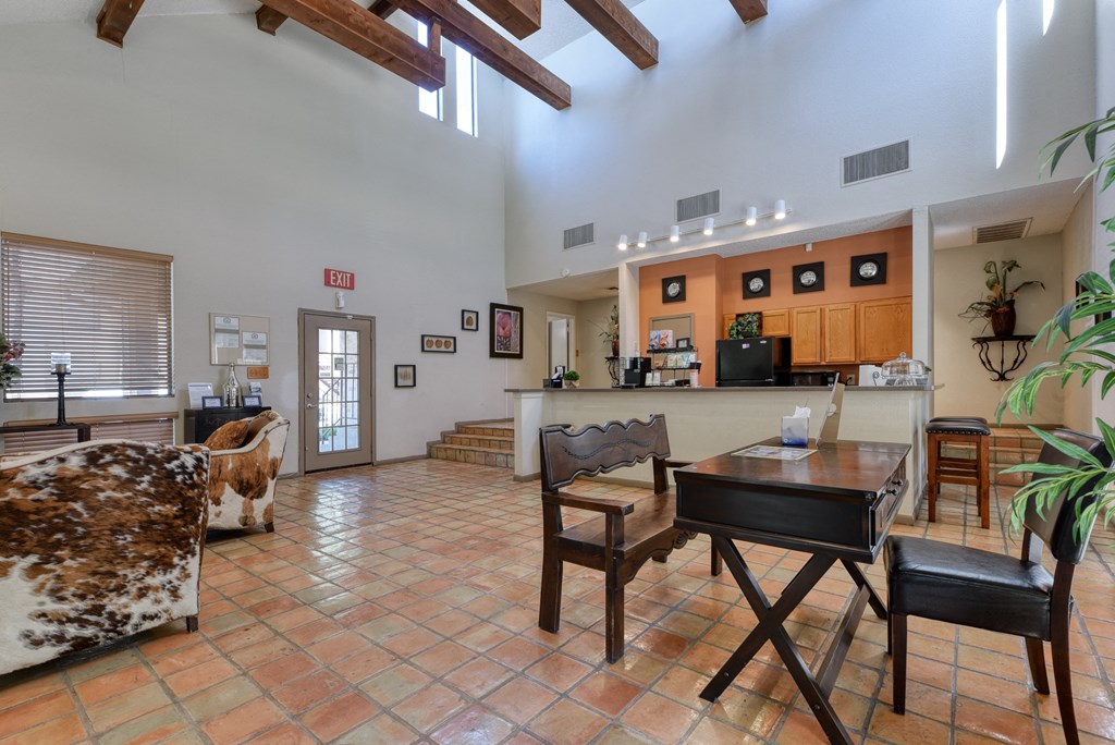a large living room with a dining table and a kitchen in the background