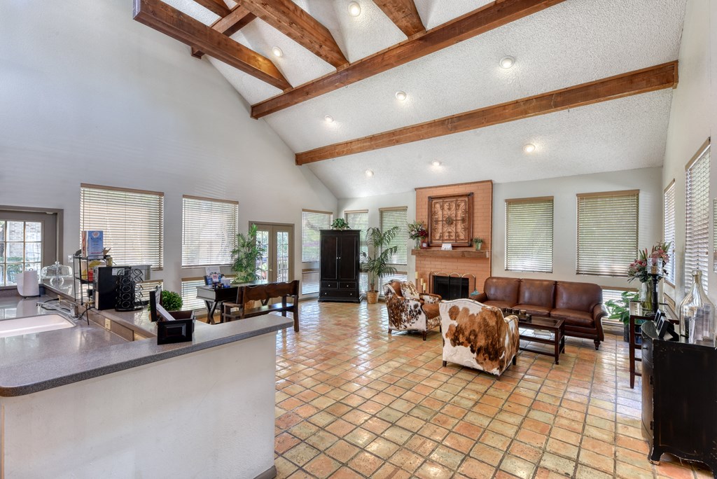 a large living room with a fireplace and a large tile floor