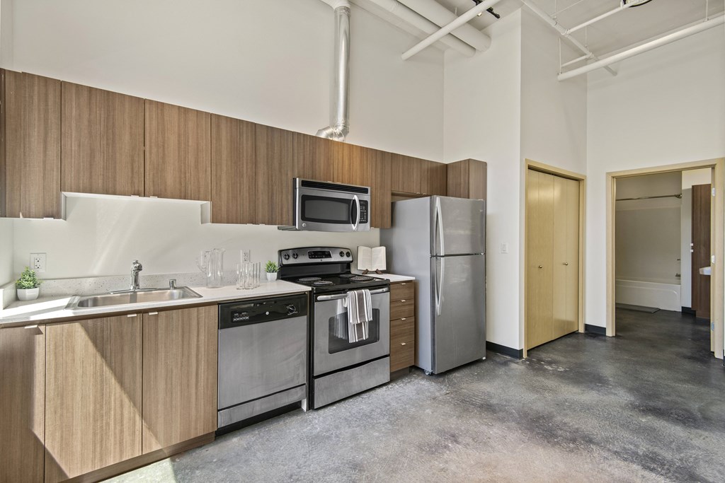 a kitchen with wood cabinets and stainless steel appliances
