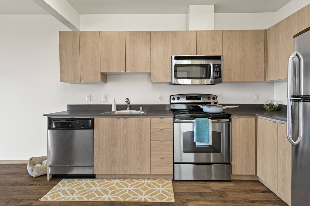 a kitchen with wooden cabinets and stainless steel appliances