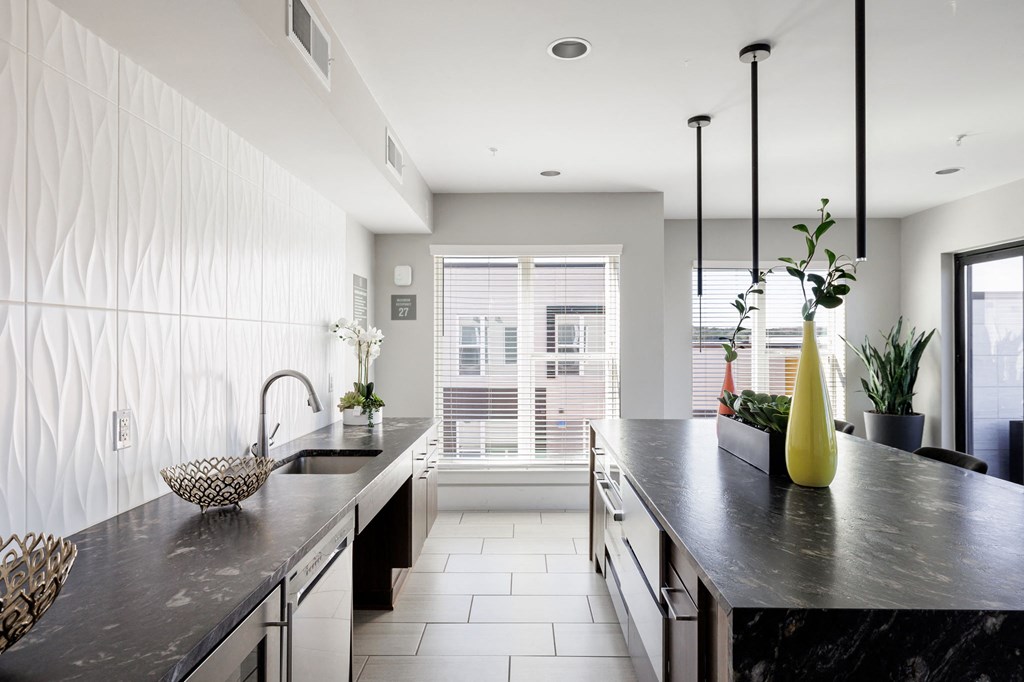 a large kitchen with a large counter top and a window