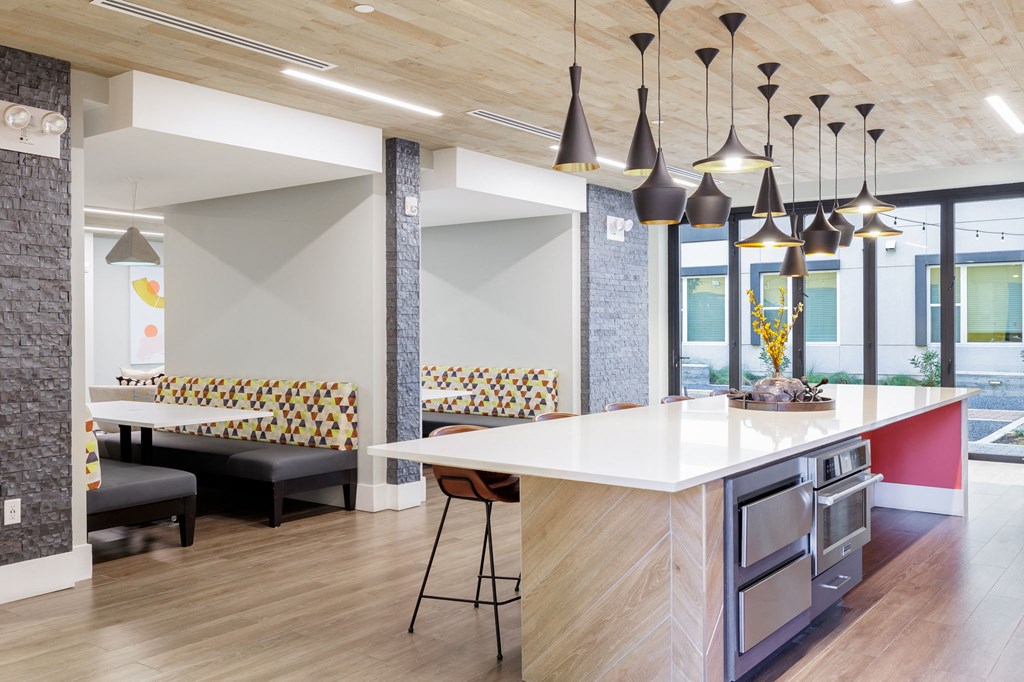 a kitchen and dining area in a modern office space