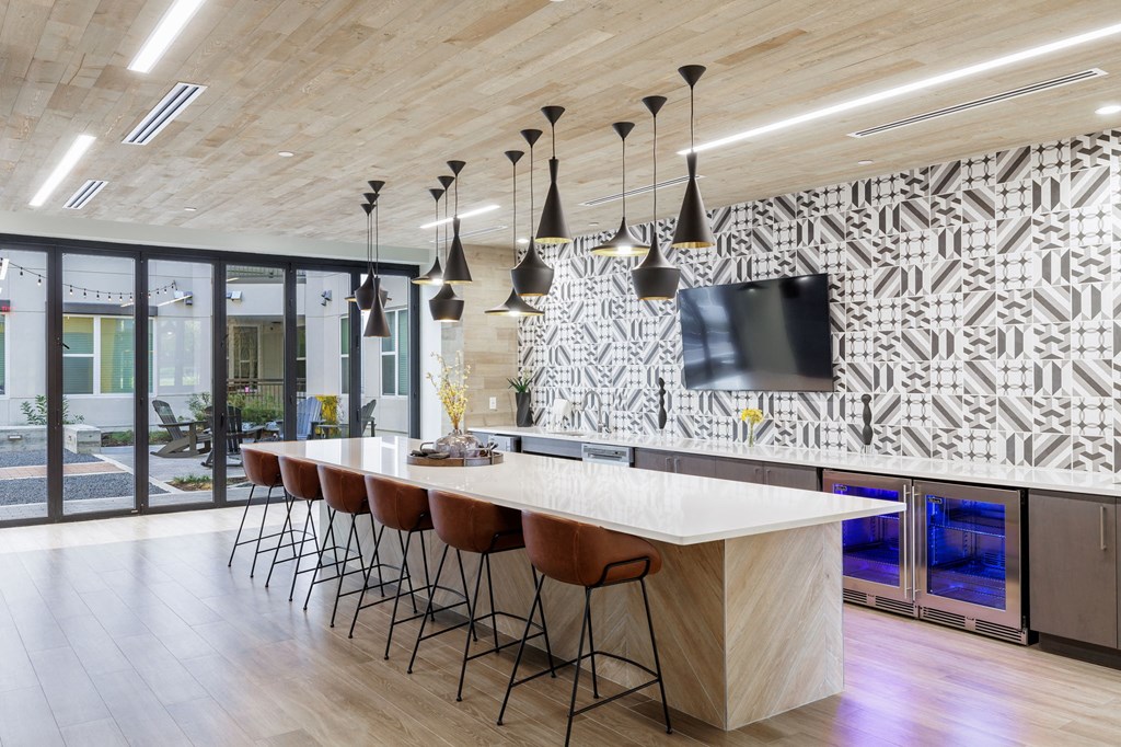 a large kitchen with a large island and a tv on the wall