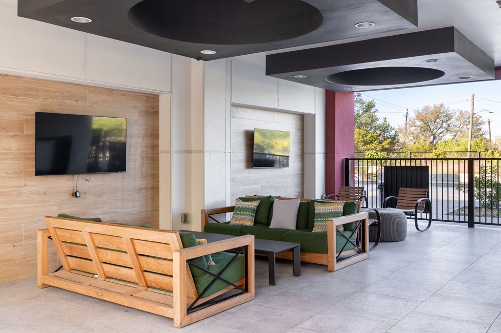 a lobby with couches and chairs and a fireplace
