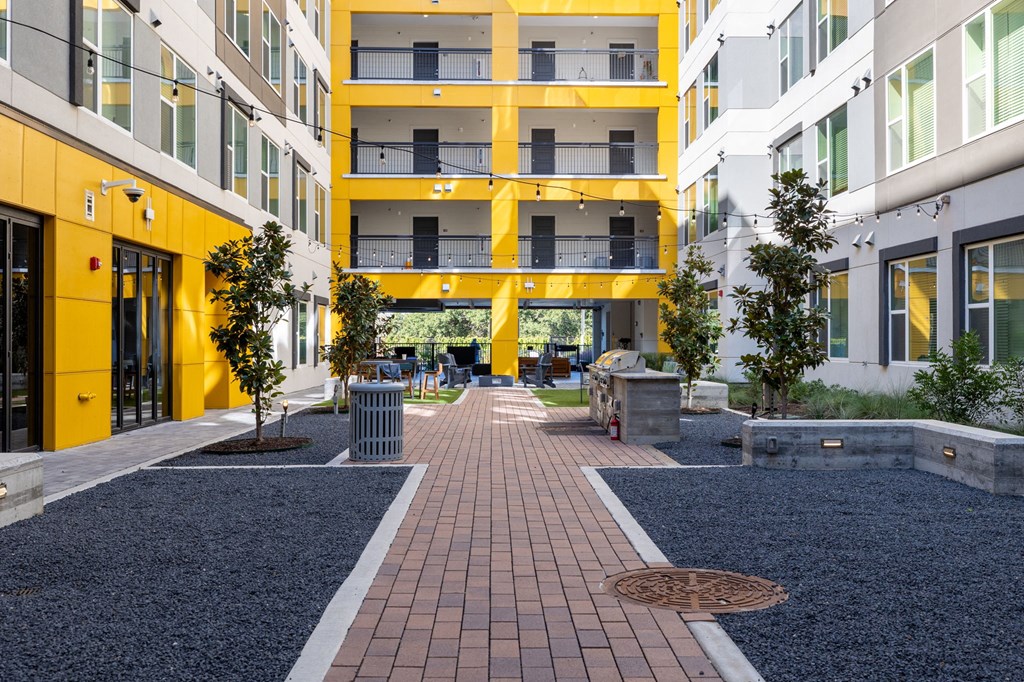 an exterior view of an apartment building with a walkway