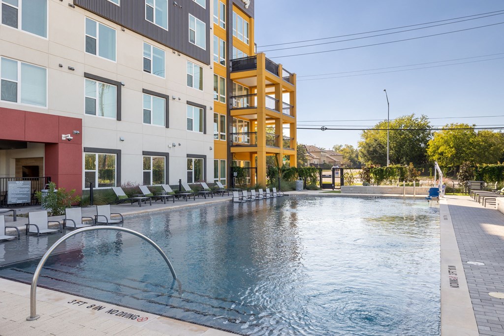 a swimming pool with a building in the background