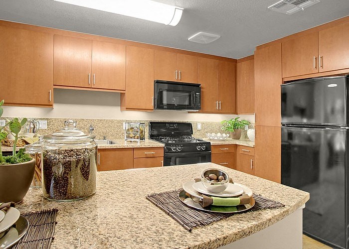 a kitchen with a granite counter top and stainless steel appliances