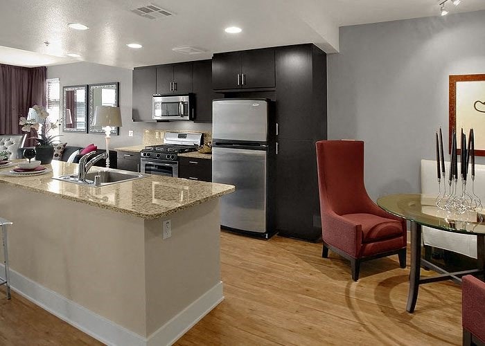 a kitchen with a stove top oven next to a table