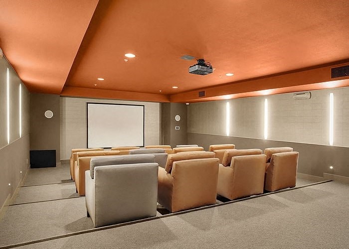 a room with a projector screen and chairs