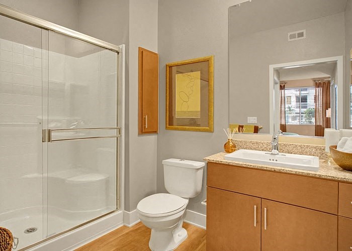 a bathroom with a toilet sink and shower