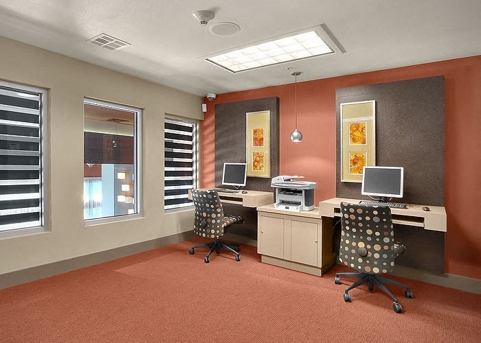 a room with two computers and two chairs