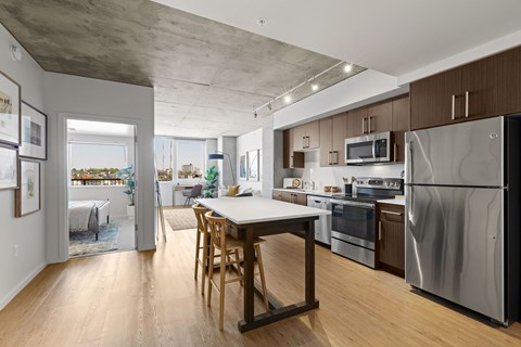 A kitchen with a table and chairs in the middle of it.