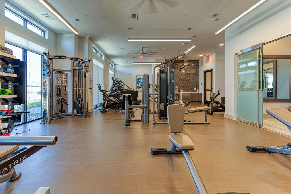 a workout room with weights and other exercise equipment