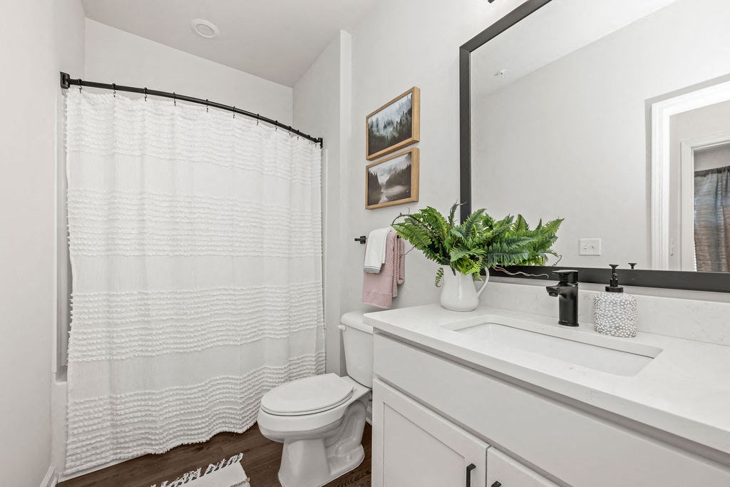 a bathroom with a white sink and a toilet