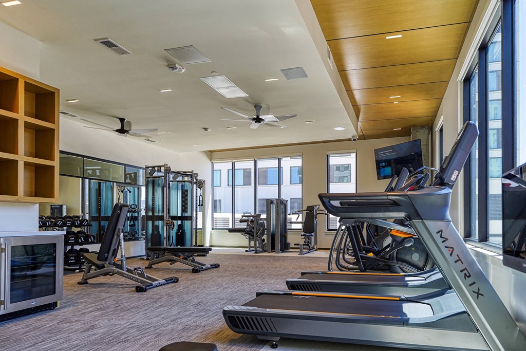 the gym with treadmills and other exercise equipment at the belgard apartments