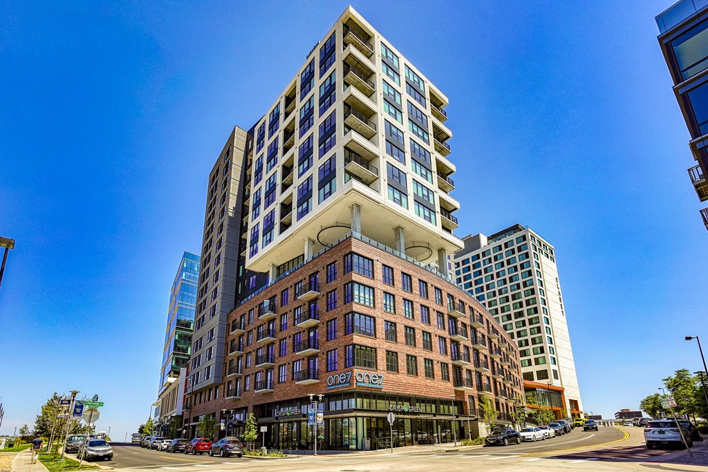 a tall building on a city street with a blue sky