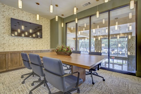 A conference room with a long table and chairs.