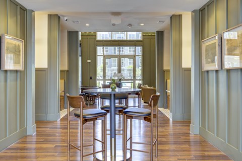 A dining room with a table and chairs.