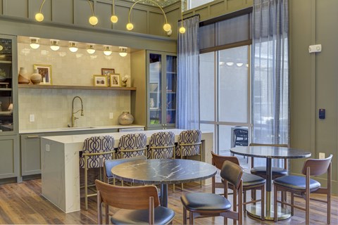 A modern kitchen with a dining table and chairs.